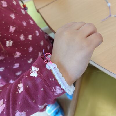 Das Foto zeigt ein fertiges Perlenarmband mit farblosen Perlen.